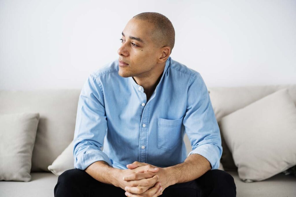 a man with alcohol addiction problem sitting on a couch