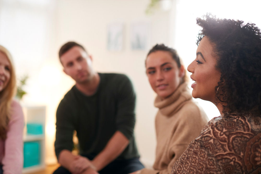 woman sharing with addiction therapy group