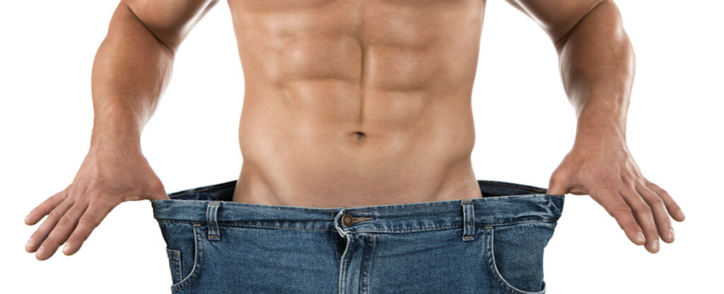 man holding the waist of his pants to show he's lost weight
