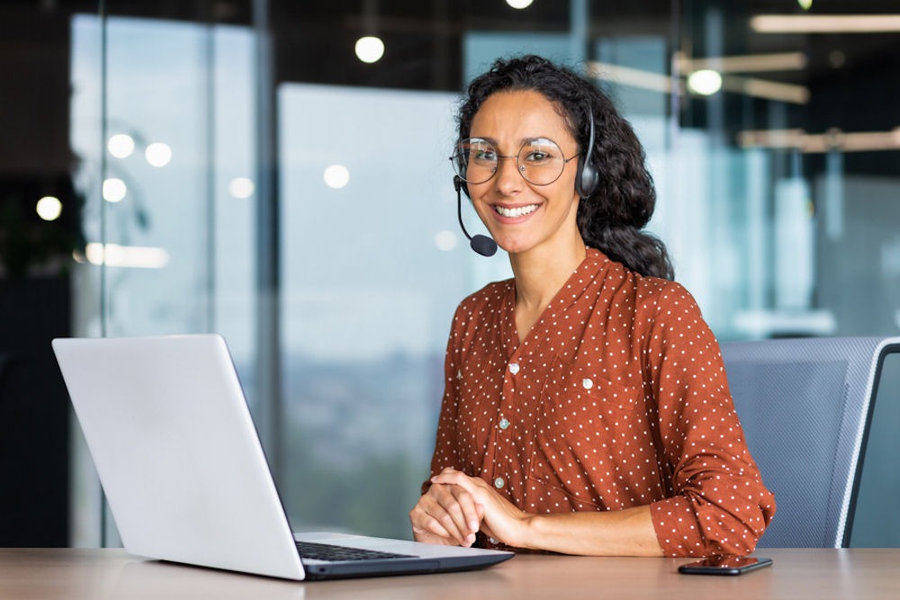 call center operator sitting at desk for calls