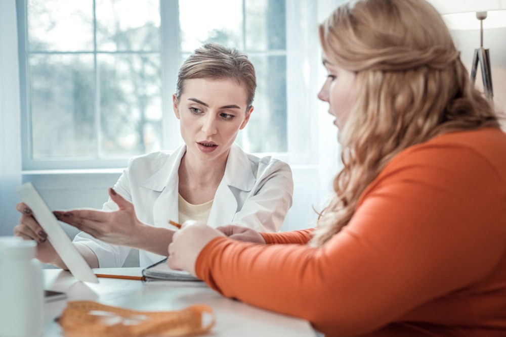 medical professional discussing medication and treatment with patient