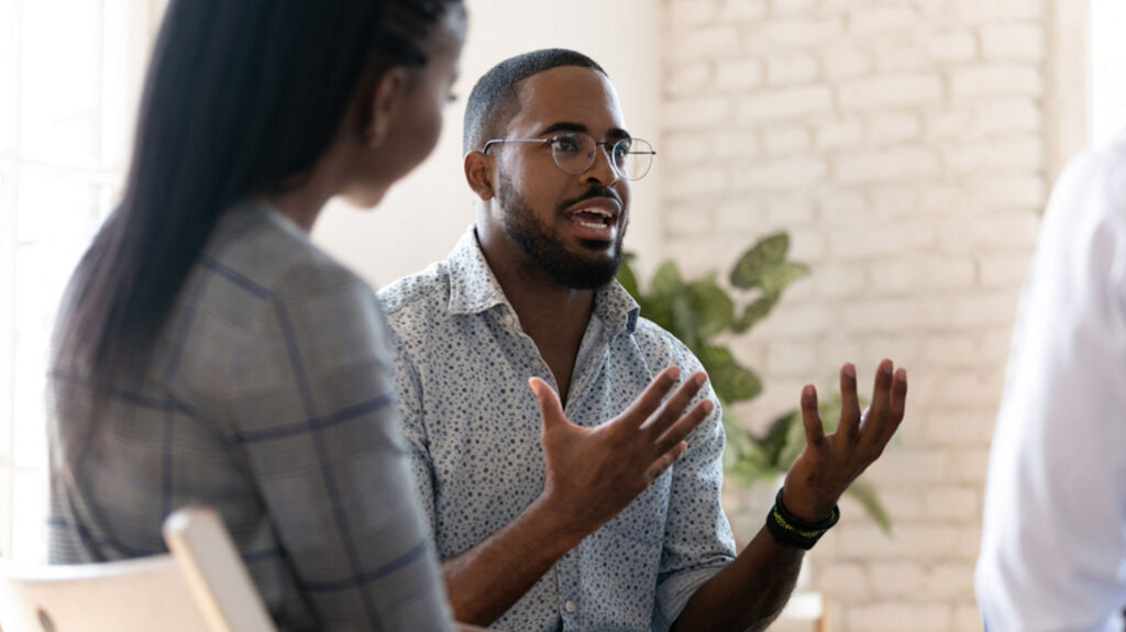 man in group talking with his hands