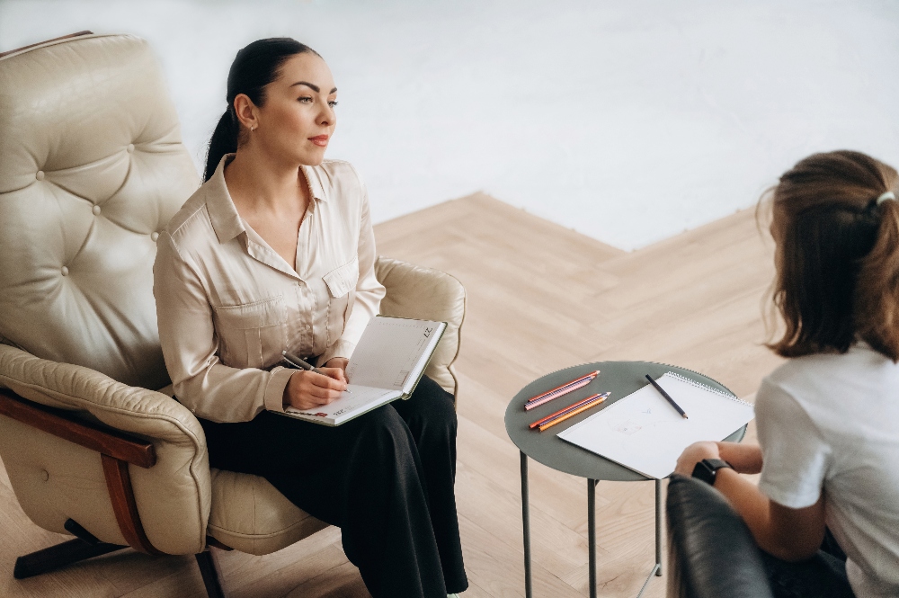 Girl at a psychologist's appointment. therapist talking to woman with drug addiction in colorado
