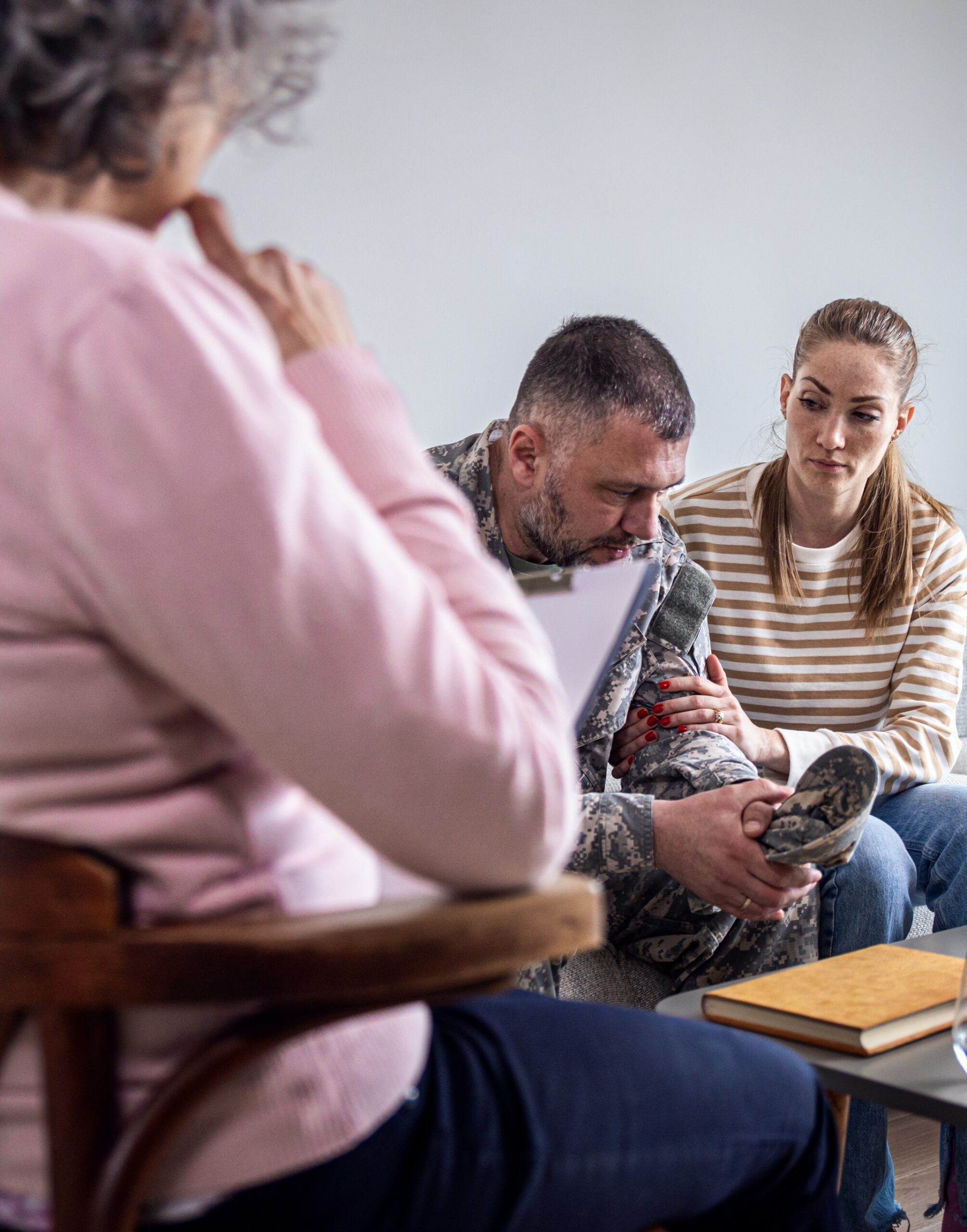 Soldier with his wife having therapy meeting with senior female psychologist. family therapy in boulder colorado