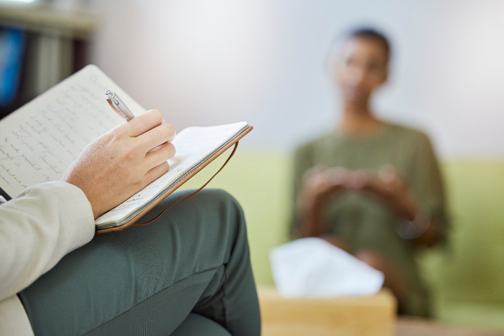 therapy-therapist-notebook-and-woman-listening-h-2025-04-06-08-37-02-utc (1) woman therapist taking notest for client with drug addiction in colorado