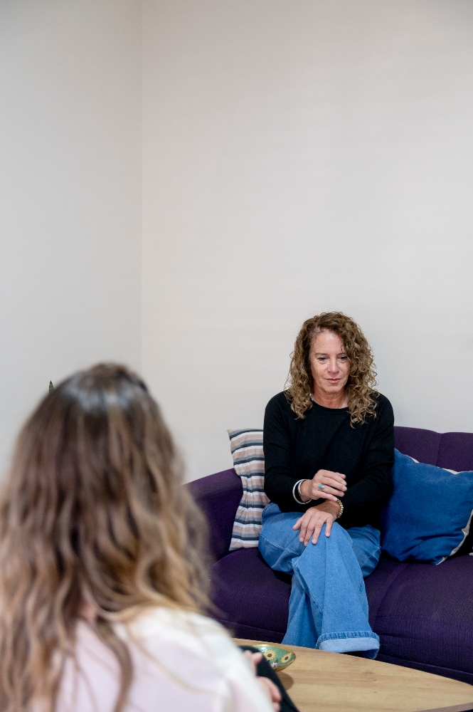 woman-sitting-on-the-sofa-while-having-a-therapy-s-2025-02-09-23-13-27-utc (1) woman meeting with therapist as a part of an iop addiction program