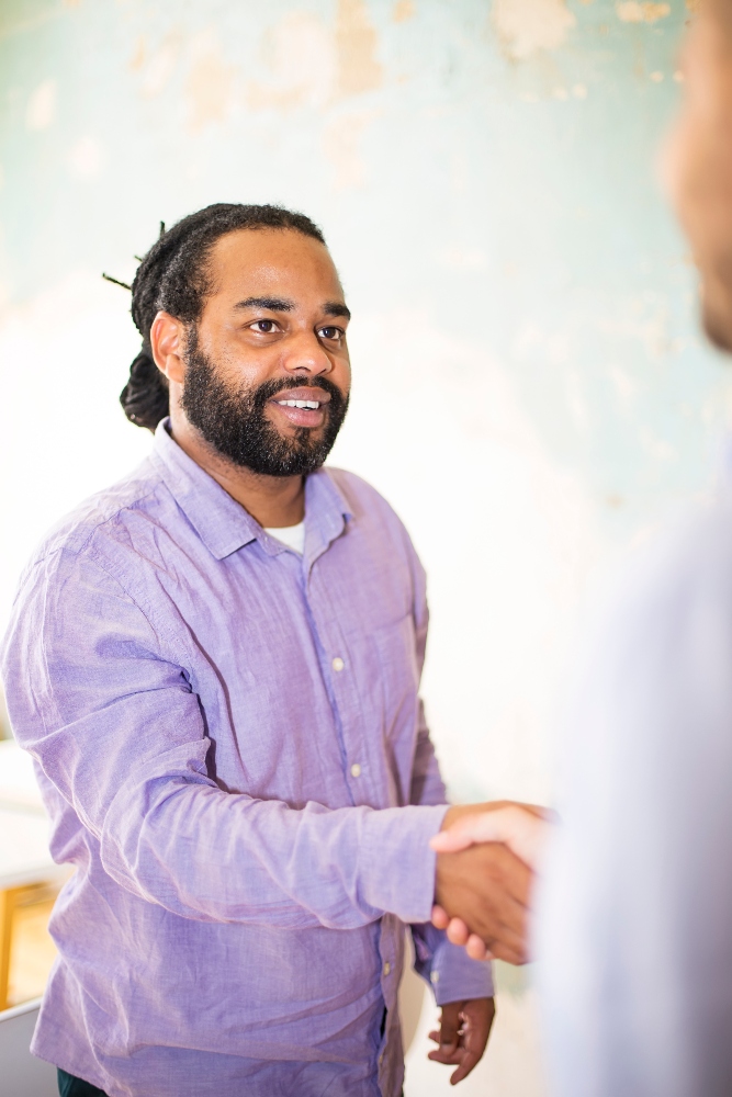 Closeup image of business partners making handshake in grunge office therapist shaking hands with patient before emdr session