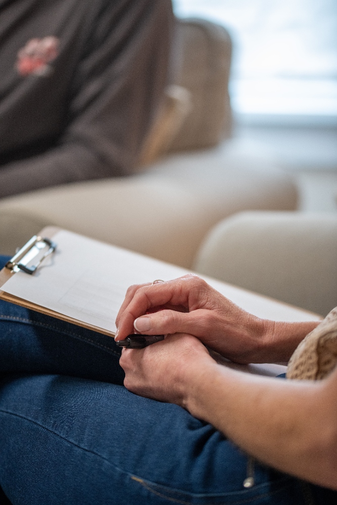 therapist taking notes during cbt session