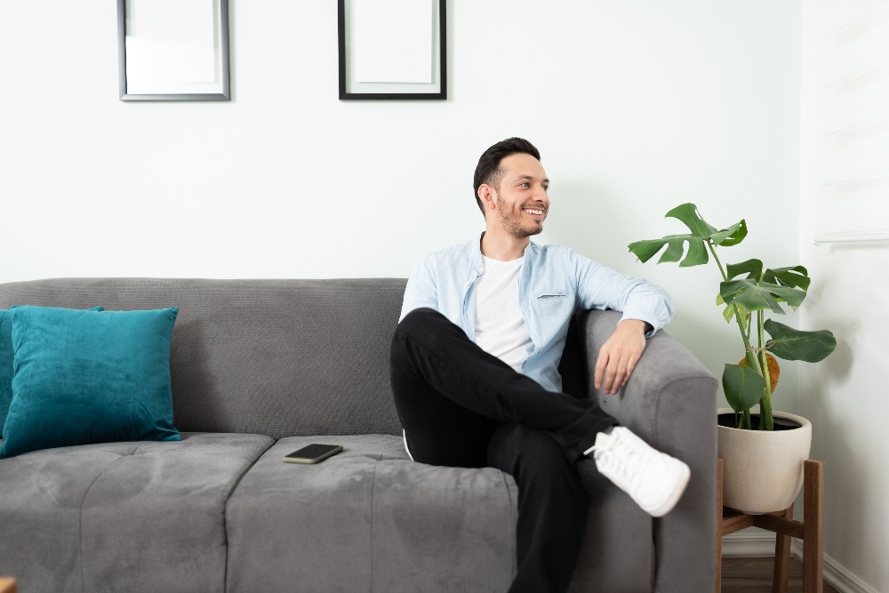 man sitting on couch at a sober living home