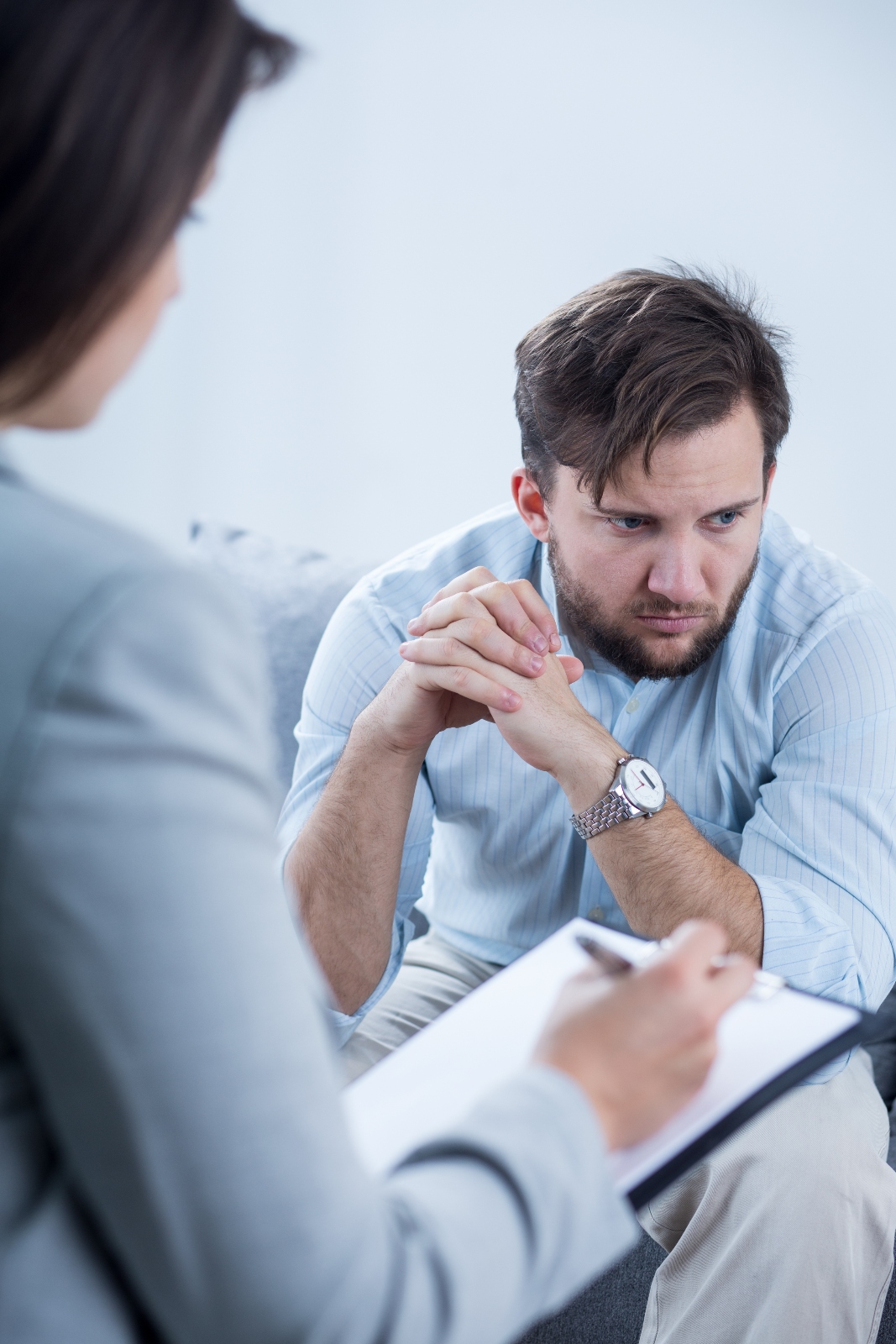 male-young-patient-with-mental-disease-at-doctor-s-2025-10-02-22-52-31-utc (1) man meeting with therapist got her