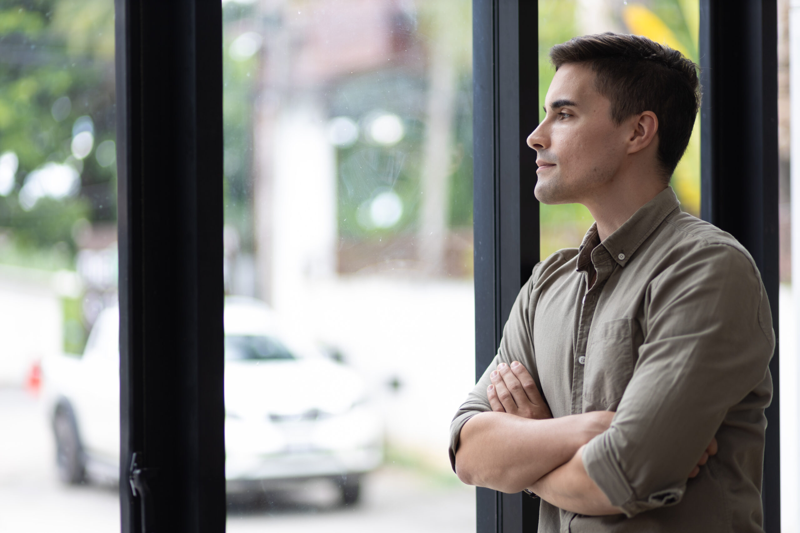 man staring out window