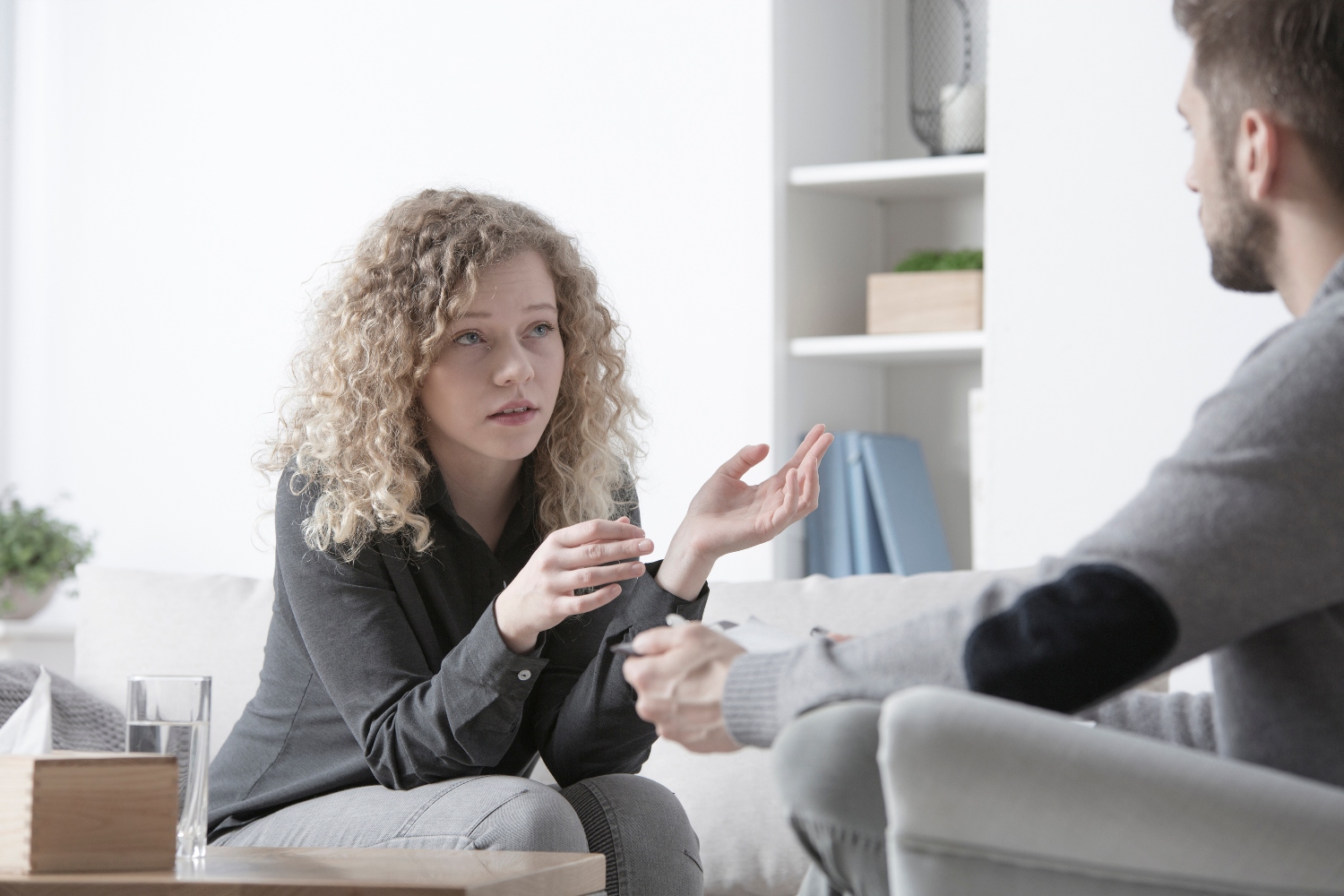 teenage girl speaking to male therapist